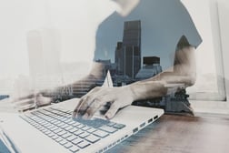 Double exposure of businessman working with new modern computer to represent ERP business intelligence