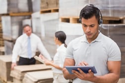 manager using digital tablet in warehouse to show AI in Inventory Management