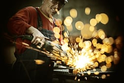 Industrial worker cutting and welding metal with many sharp sparks-2