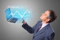 Man holding laptop projecting financial information, diagrams and charts